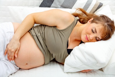 Beautiful pregnant woman sleeping  on sofa